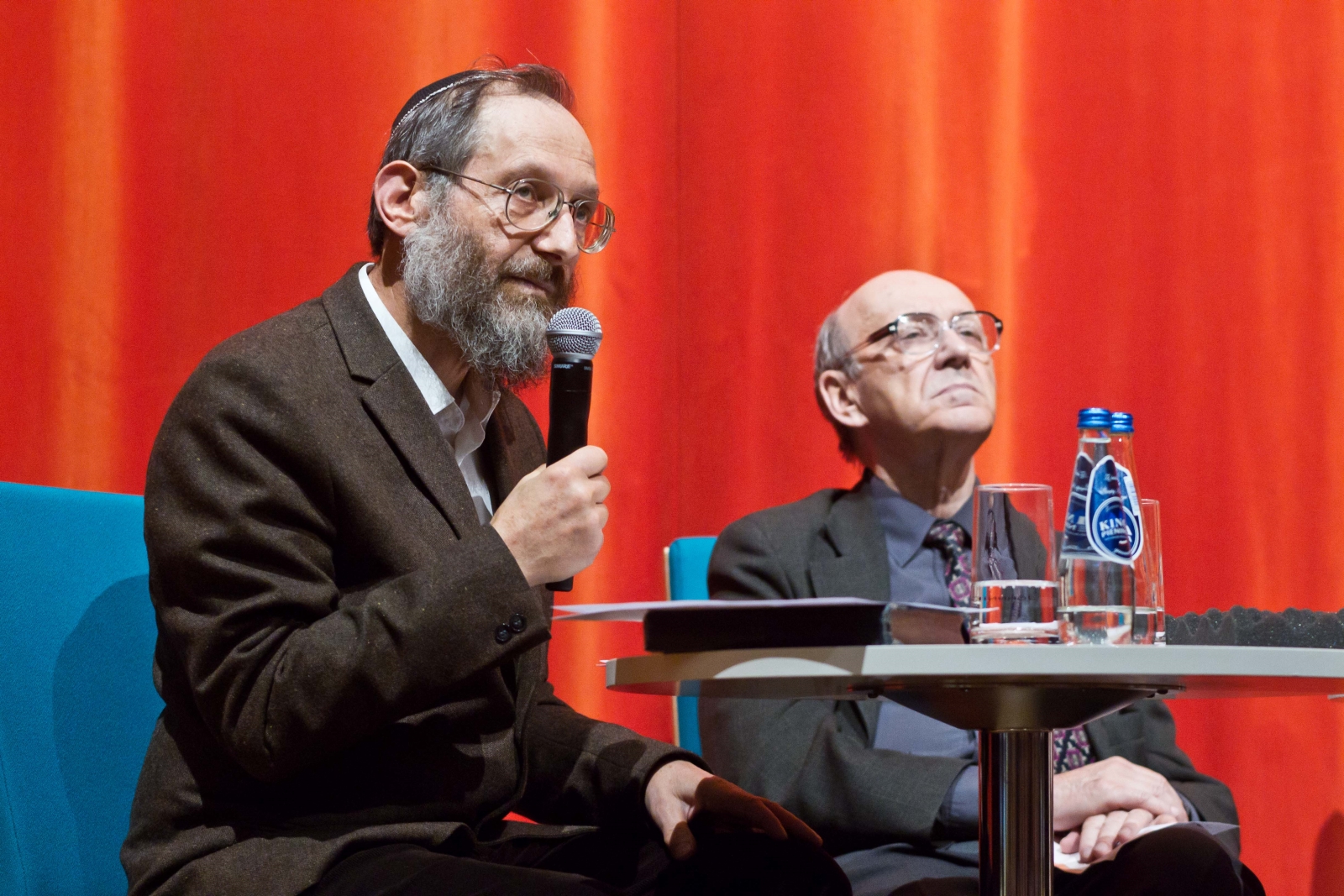 Przy stoliku siedzą dwaj prelegenci dyskusji "Uwierzyć w muzeum" w 2013 r.