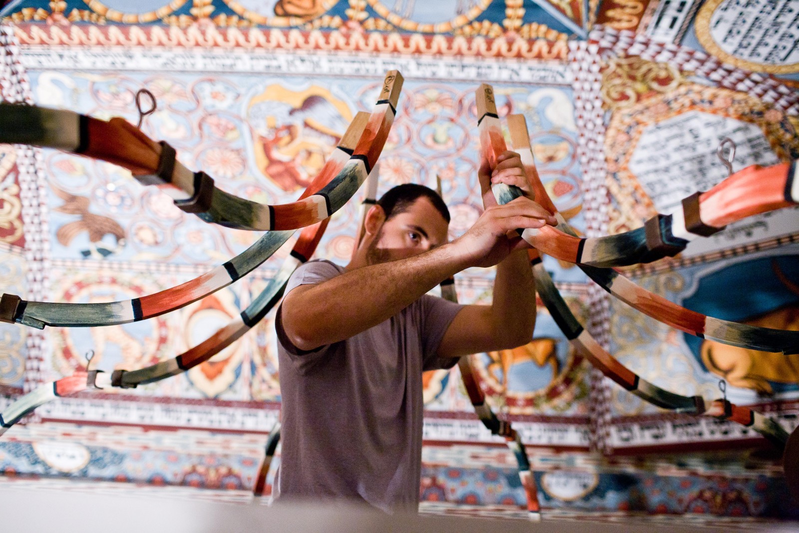 Mężczyzna mocuje fragment fasady synagogi, która znajduje się w Muzeum POLIN.
