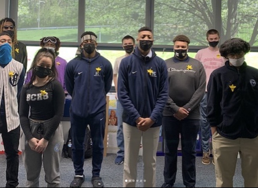 Students from Bishop canevin High School in Pittsburg with paper daffodils on their clothes.