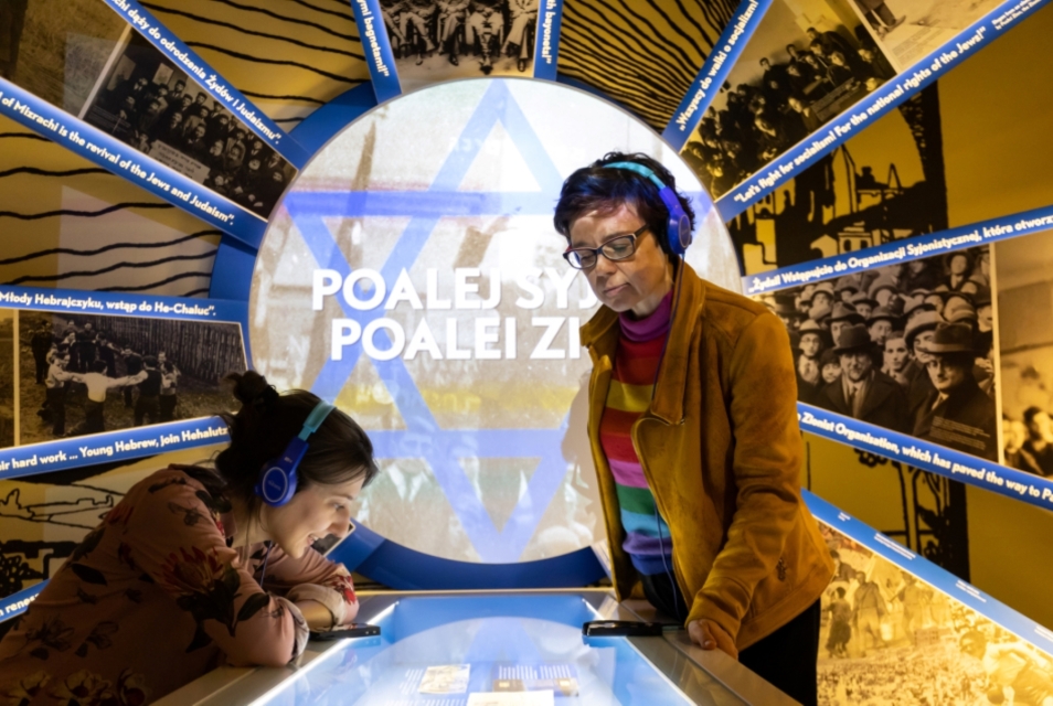 Two women are exploring Core Exhibition with audio guides over their heads.