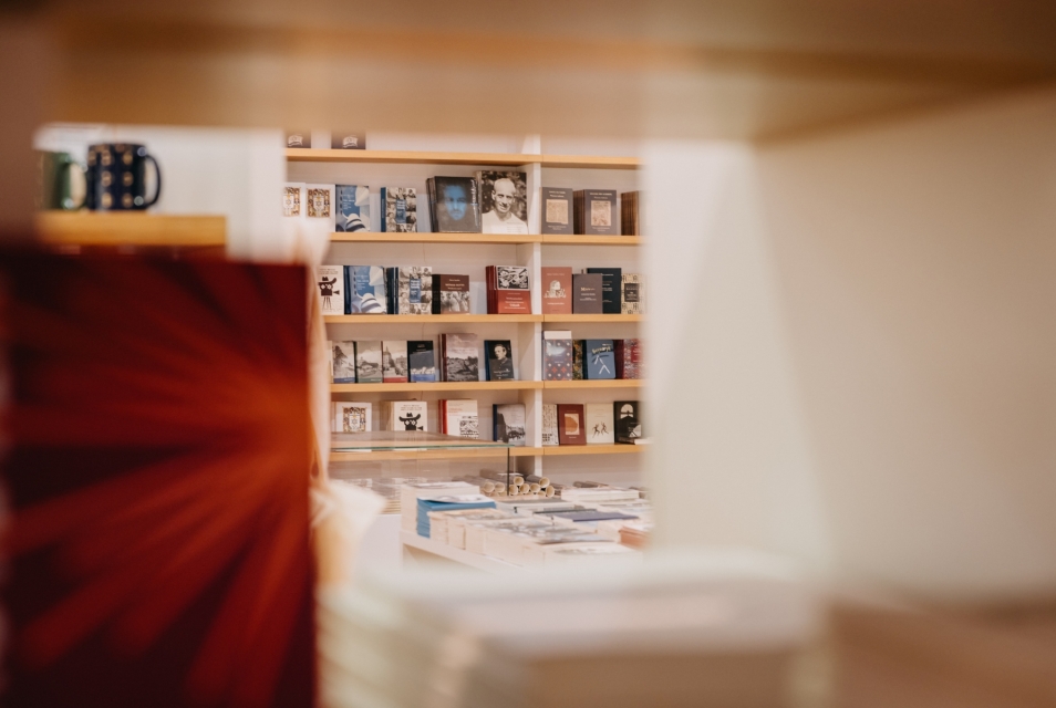 Books arranged on shelves in the Austeria shop at POLIN.