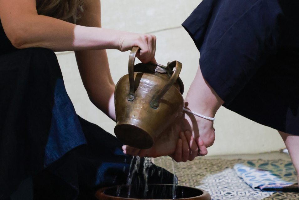 Dominika Laster: Performance IN TENT, Dominika washes a traveler’s feet