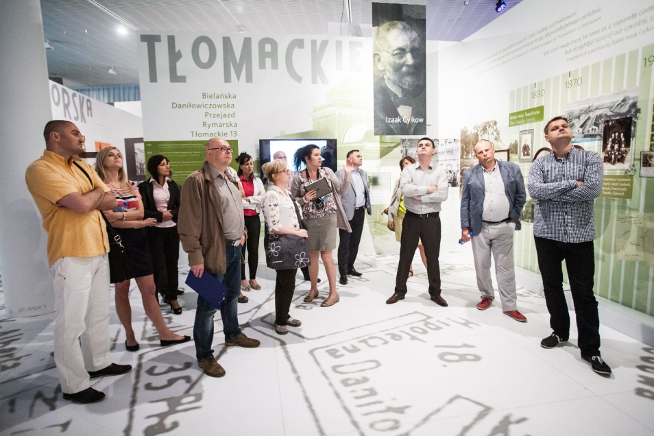 Grupa ludzi zwiedza wystawę czasową w Muzeum POLIN.