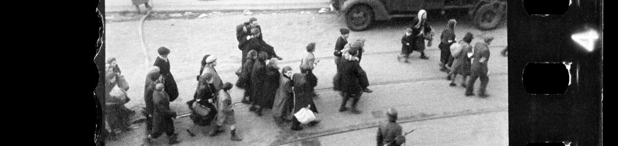 Warszawska ulica. Żydzi prowadzeni przez Niemców na Umschlagplatz. / Warsaw Street - the Jews on their way to Umschlagplatz. Around them there are German soldiers.