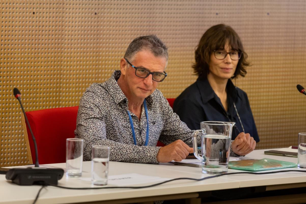 Kobieta i mężczyzna siedzą przy stole w sali konferencyjnej podczas warsztatów GEOP 2023.