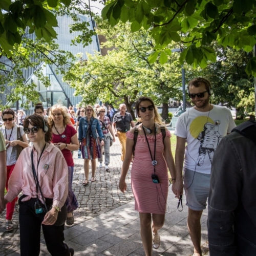 Grupa osób podczas spaceru miejskiego w okolicy Muzeum POLIN.