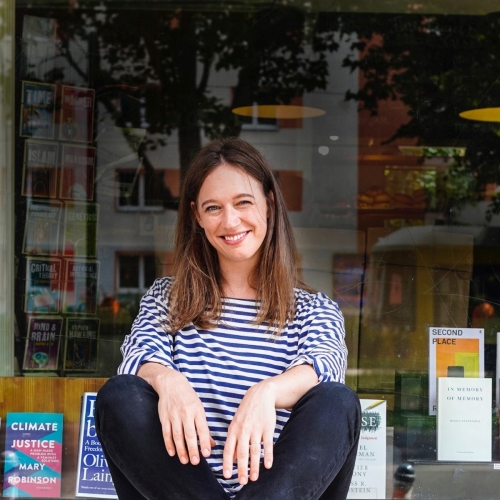 Laurel Kratochvila in front of a display window in a bookshop.