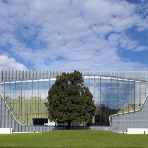 POLIN Museum building among the trees.