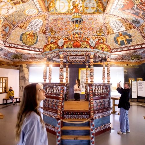 Kilkoro zwiedzających stoi przy rekonstrukcji synagogi z Gwoźdźca na wystawie stałej.